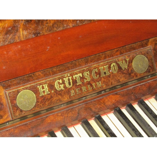 2222 - An upright iron framed overstrung piano by H Gutschow of Berlin in a figured walnut case with origin... 