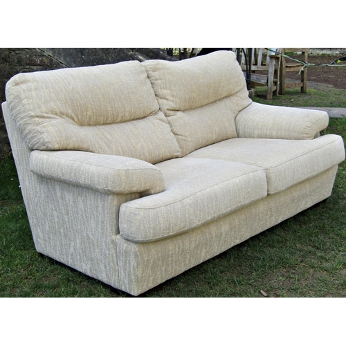 2235 - A three seat sofa, cream ground with repeating reed patterned upholstery, with loose squab cushions,... 