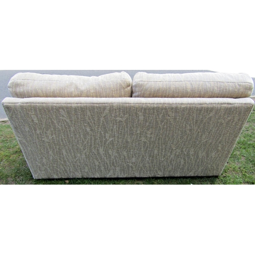 2235 - A three seat sofa, cream ground with repeating reed patterned upholstery, with loose squab cushions,... 