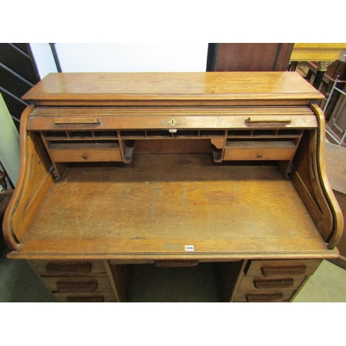 2266 - Oak roll top desk with serpentine tambour top enclosing a fitted interior within an arrangement of n... 