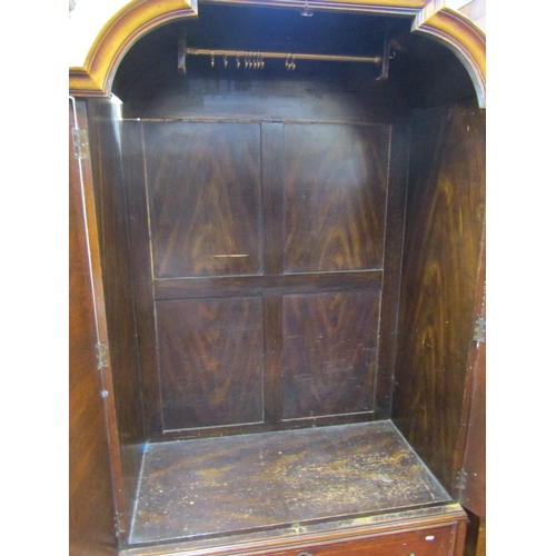 2338 - A Queen Anne style walnut veneered wardrobe or hanging cupboard, the arched and panelled doors with ... 