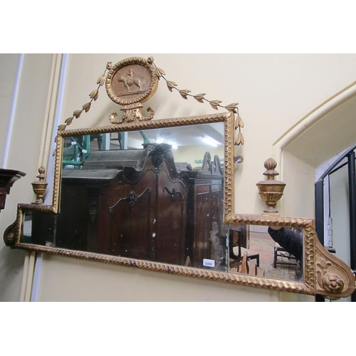 2355 - A Regency overmantle mirror with repeating, urn and harebell detail, central roundle incorporating a... 