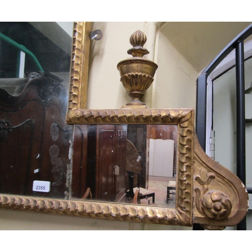 2355 - A Regency overmantle mirror with repeating, urn and harebell detail, central roundle incorporating a... 