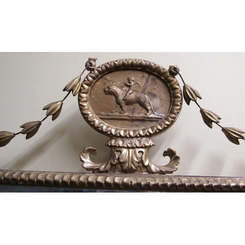 2355 - A Regency overmantle mirror with repeating, urn and harebell detail, central roundle incorporating a... 