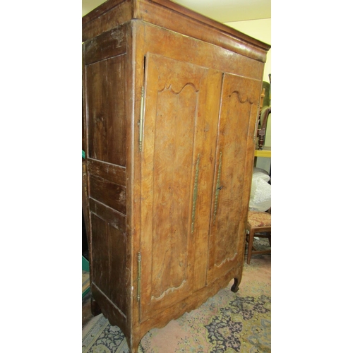 2359 - 18th century fruitwood armoire enclosed by two panelled doors with brass fittings, the interior encl... 