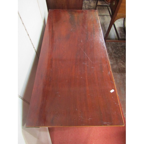 2364 - A Georgian mahogany fold over top table of rectangular form raised on four square taper supports wit... 