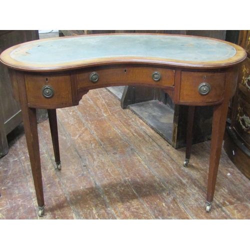 2375 - An inlaid Edwardian mahogany kidney shaped writing table with three drawers, raised on square tapere... 