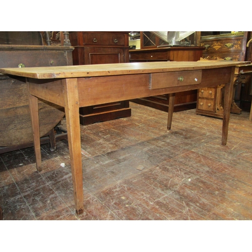 2392 - A French provincial farmhouse table mainly in fruitwood, the plank top with cleated ends, rasied on ... 