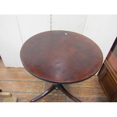 2394 - An early 19th century mahogany occasional table the circular top raised on a vase shaped pillar and ... 