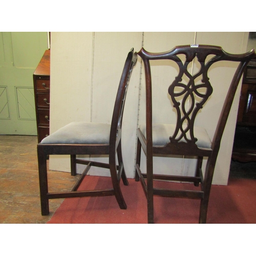 2395 - Four Georgian mahogany dining chairs with carved and interlaced splats, the drop in seats on square ... 