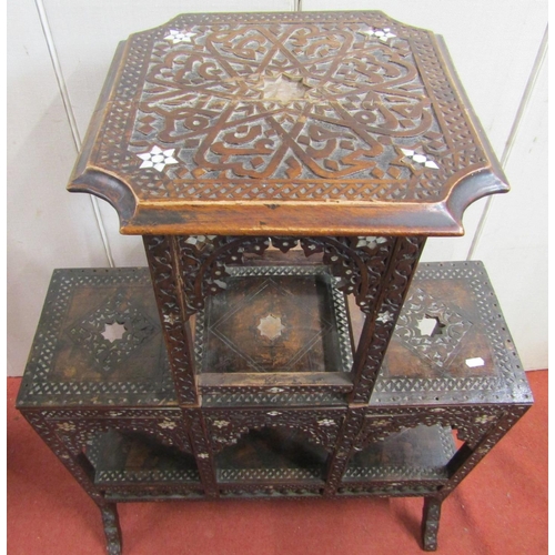 2396 - A Moroccan occasional table on three tiers with carved finish and mother of pearl inlaid detail