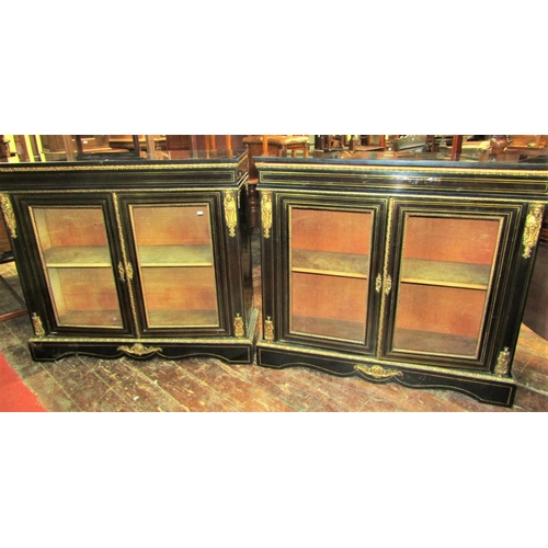 2404 - A pair of Victorian brass and ebonised inlaid pier cabinets, each enclosed by a pair of panelled gla... 