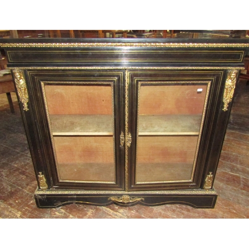 2404 - A pair of Victorian brass and ebonised inlaid pier cabinets, each enclosed by a pair of panelled gla... 