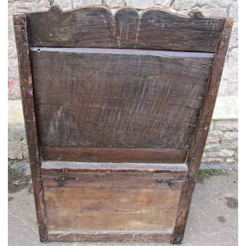 2405 - A late 17th century oak wainscot chair with box seat, the back with carved detail, set beneath a sha... 