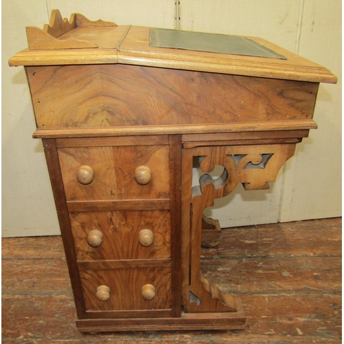 2408 - A Victorian style walnut davenport fitted with an arrangement of drawers, the fall flap enclosing a ... 