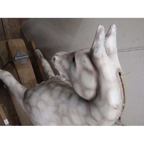 2409 - A carved timber dapple grey rocking horse raised on a central rocker, 110cm high approx max