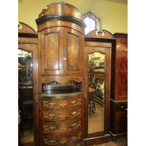 2410 - A late 19th century rosewood triple compactum wardrobe, the bow fronted centre fitted with an arrang... 