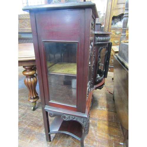 2411 - An Edwardian mahogany chiffonier base, with bowfronted centre flanked by further glazed panelled doo... 