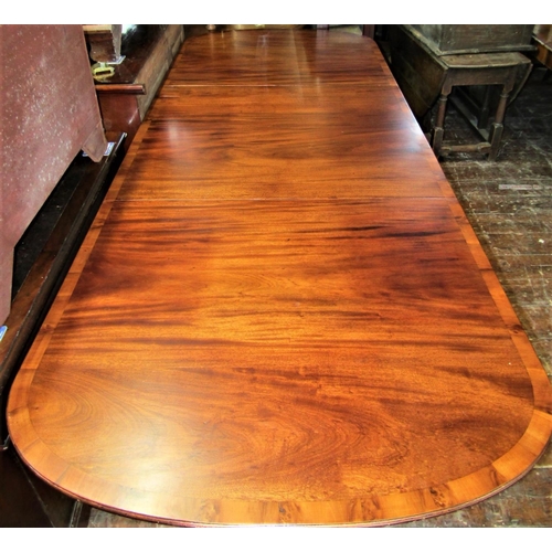 2414 - A Georgian style mahogany three pedestal dining table on turned columns and reeded sabre supports, t... 