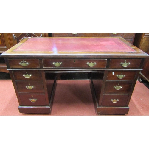 2419 - An Edwardian pedestal writing desk of nine drawers, with inset leather top on a plinth base, 120cm w... 