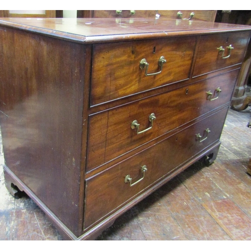 2422 - A Georgian mahogany chest of two long and two short drawers on bracket supports, 110cm wide