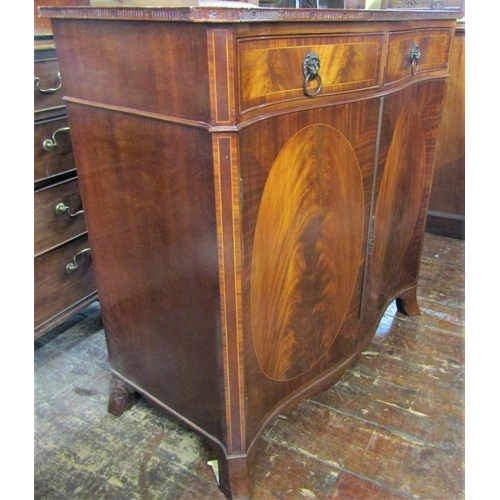 2425 - A good quality reproduction serpentine side cabinet enclosed by two panelled doors and two drawers, ... 