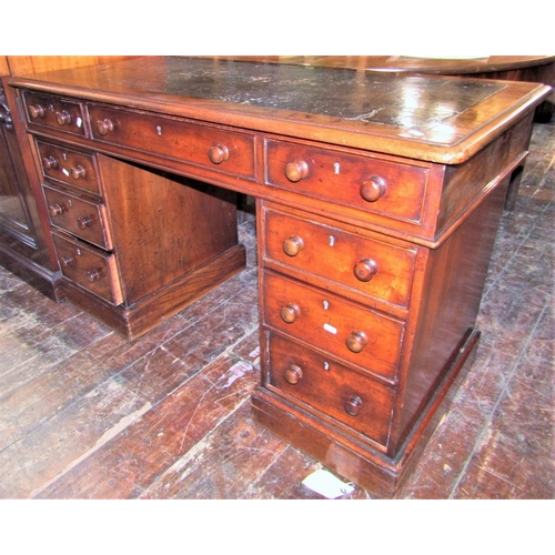 2426 - A Victorian mahogany pedestal writing desk of nine drawers, raised on plinth base, with inset leathe... 