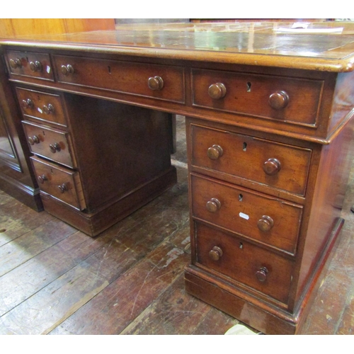 2426 - A Victorian mahogany pedestal writing desk of nine drawers, raised on plinth base, with inset leathe... 