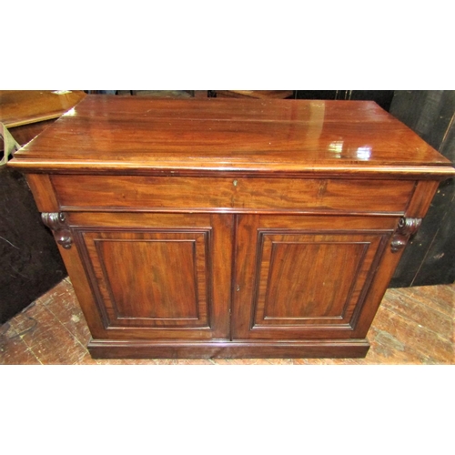 2427 - A Victorian mahogany side cupboard enclosed by two panelled doors enclosing an arrangement of drawer... 