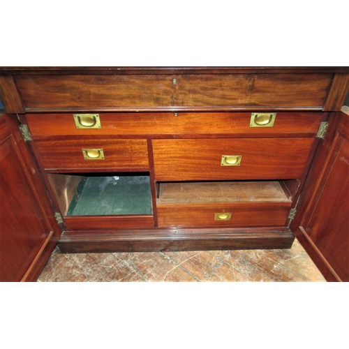 2427 - A Victorian mahogany side cupboard enclosed by two panelled doors enclosing an arrangement of drawer... 