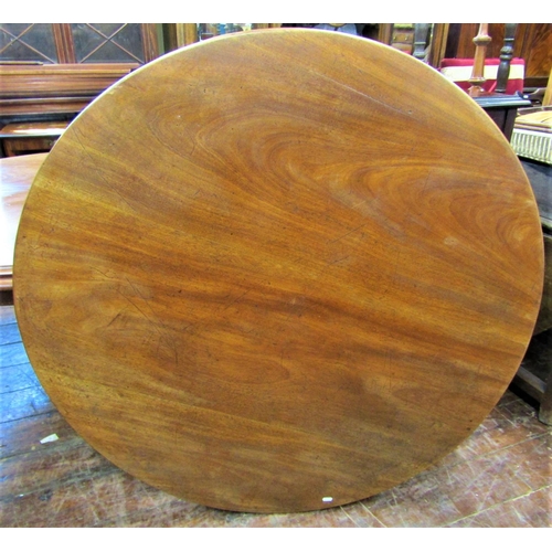 2430 - A mid Victorian period mahogany tea table the circular top 120 cm diameter raised on a tapering hexa... 