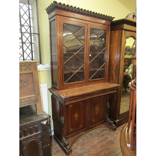 2433 - A mid 19th century mahogany library bookcase, the lower section enclosed by two panelled doors and a... 