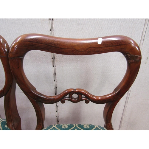 2439 - A set of four Victorian rosewood with shaped and pierced splats, upholstered seats on turned support... 