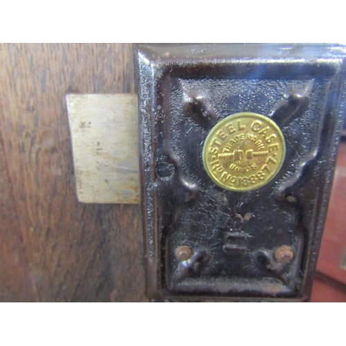 2446 - An 18th century oak hanging wall cupboard enclosed by a shaped and fielded panel with marquetry star... 