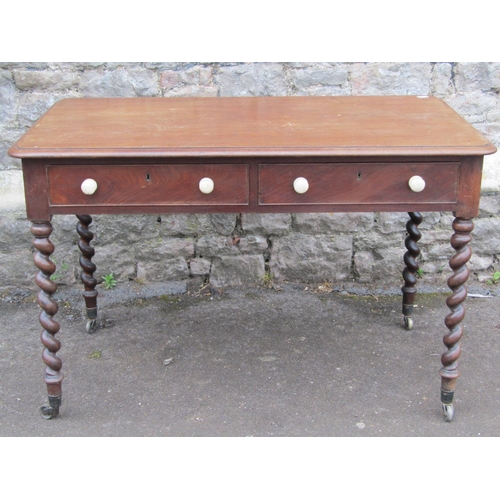 2448 - Mid 19th century mahogany writing table raised on four barley twist supports enclosing two frieze dr... 