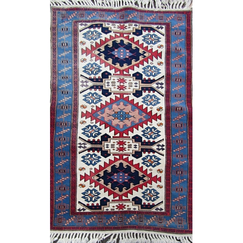 2465 - A Kazak style rug with three central medallions. 170cm x 100cm