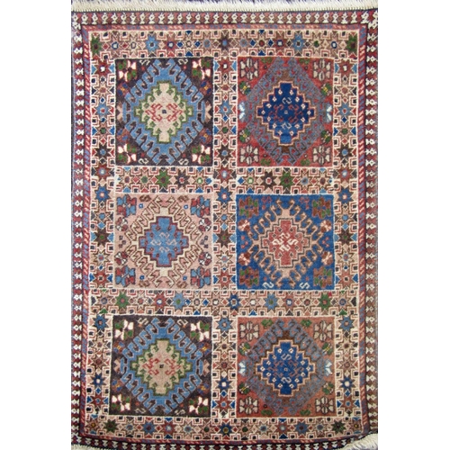 2469 - A small Iranian Yalameh rug with a panelled design. 90cm x 60 cm approx