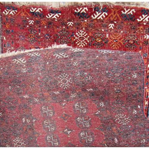 2470 - An early 20th century Turkoman rug with two rows of small elephant foot gul on a red ground.170cm x ... 