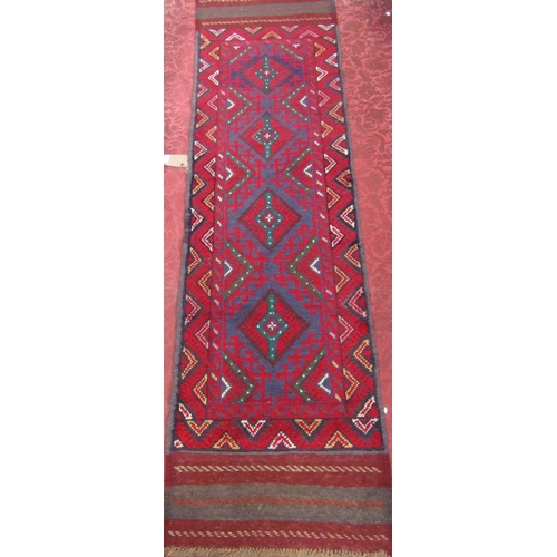 2471 - A Meshwani runner with an interlocking red and blue diamond pattern.236cm x 60cm.