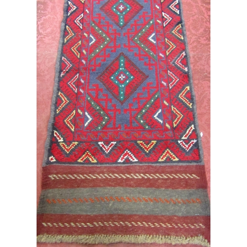 2471 - A Meshwani runner with an interlocking red and blue diamond pattern.236cm x 60cm.