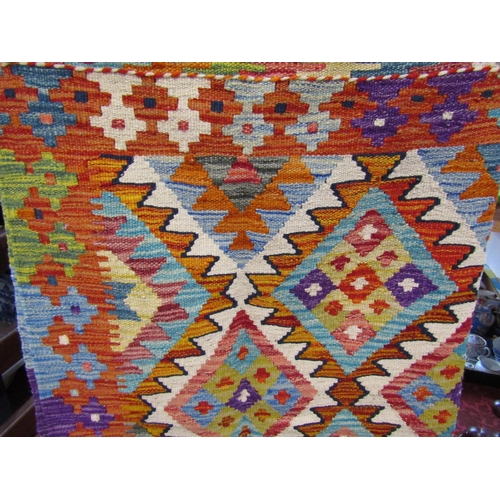 2473 - A Chobi kilim carpet, with a multi coloured diamond pattern. 198cm x 123cm.