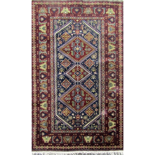 2490 - A Middle Eastern design carpet with three interlocking medallions on a purple ground. 190cm x 104cm ... 