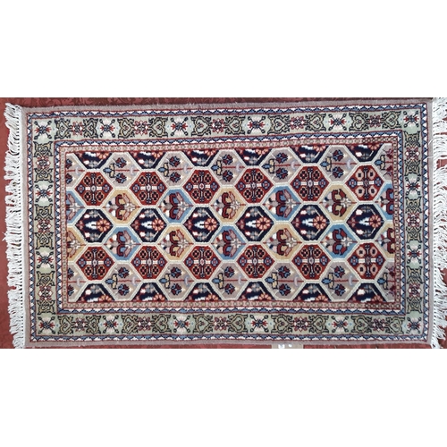 2491 - A modern Middle Eastern design carpet with an all over floral pattern. 163cm x82cm approx and anothe... 