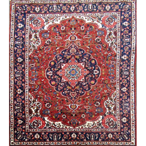 2494 - A fine Bokhara carpet with a central medallion and floral pattern on a red ground. 378cm x 285cm app... 