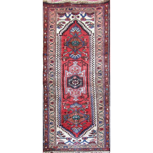 2501 - A Gharajeh runner with a central medallion with stylised birds and flowers. 180cm x 65cm approx.