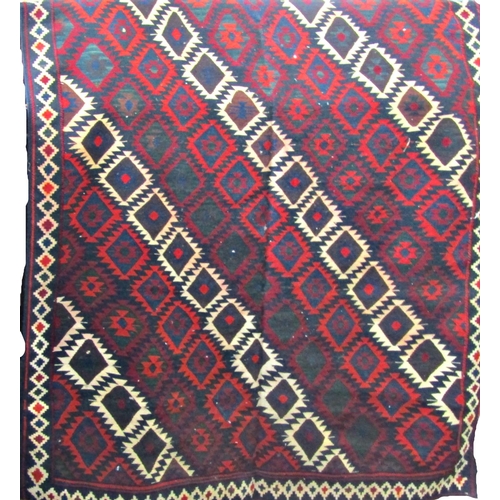 2506 - A large Shiraz kelim carpet with a multi coloured geometric pattern. 320cm x 170cm approx