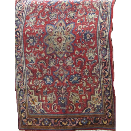 2513 - A Sarouk Mahal rug with an overall floral panel upon a red ground, 205cm x 130cm