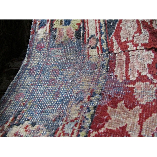 2514 - A middle eastern design carpet with a central floral medallion upon a red ground, 200cm x 140cm