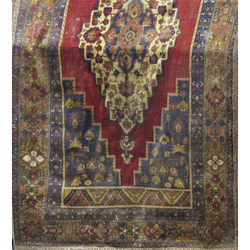 2516 - A middle eastern design carpet with stepped central medallion and all over floral pattern, 310cm x 1... 