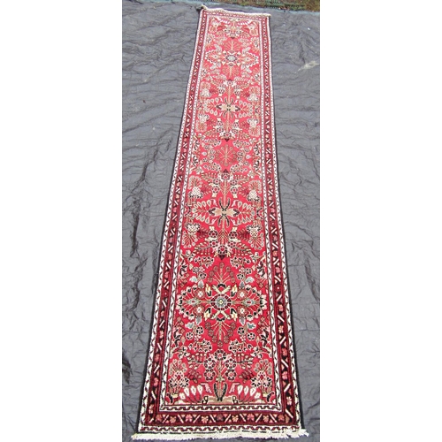 2519 - A Malayer runner with overall floral pattern on a red ground, 400 x 83cm